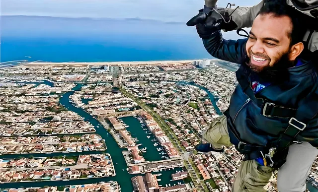 AbdurRahaman Shah skydiving above the coast